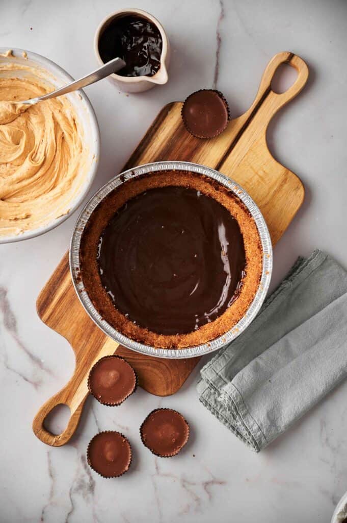 Graham cracker crust with hot fudge sauce poured on it.