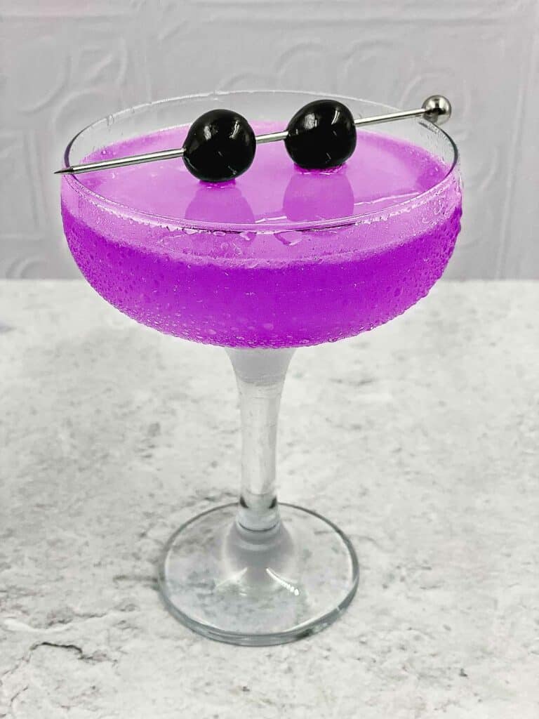 Aviation cocktail, bright pink, in a cocktail glass.