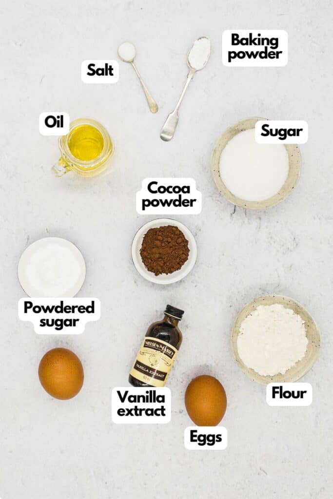 Ingredients needed, olive oil, salt, baking powder, sugar, unsweetened cocoa powder, granulated sugar, flour, eggs, vanilla extract, and powdered sugar.