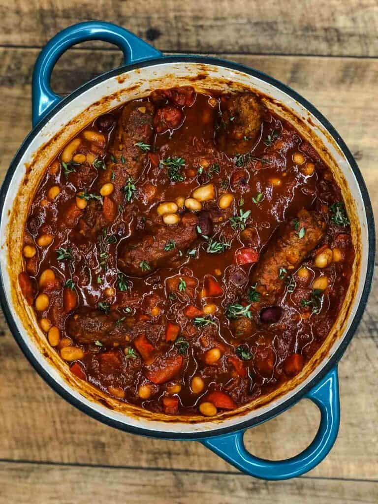 A vegetarian sausage casserole in a Dutch oven.