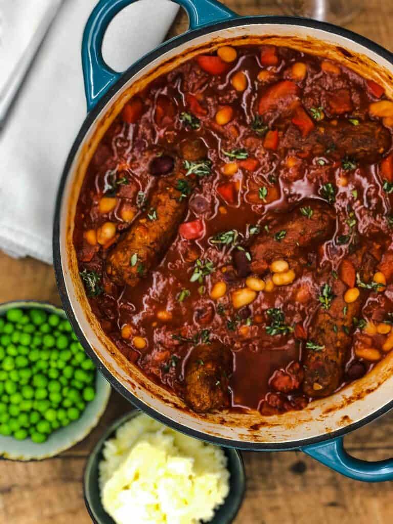 Veggie sausage and bean casserole with peas and mashed potato.