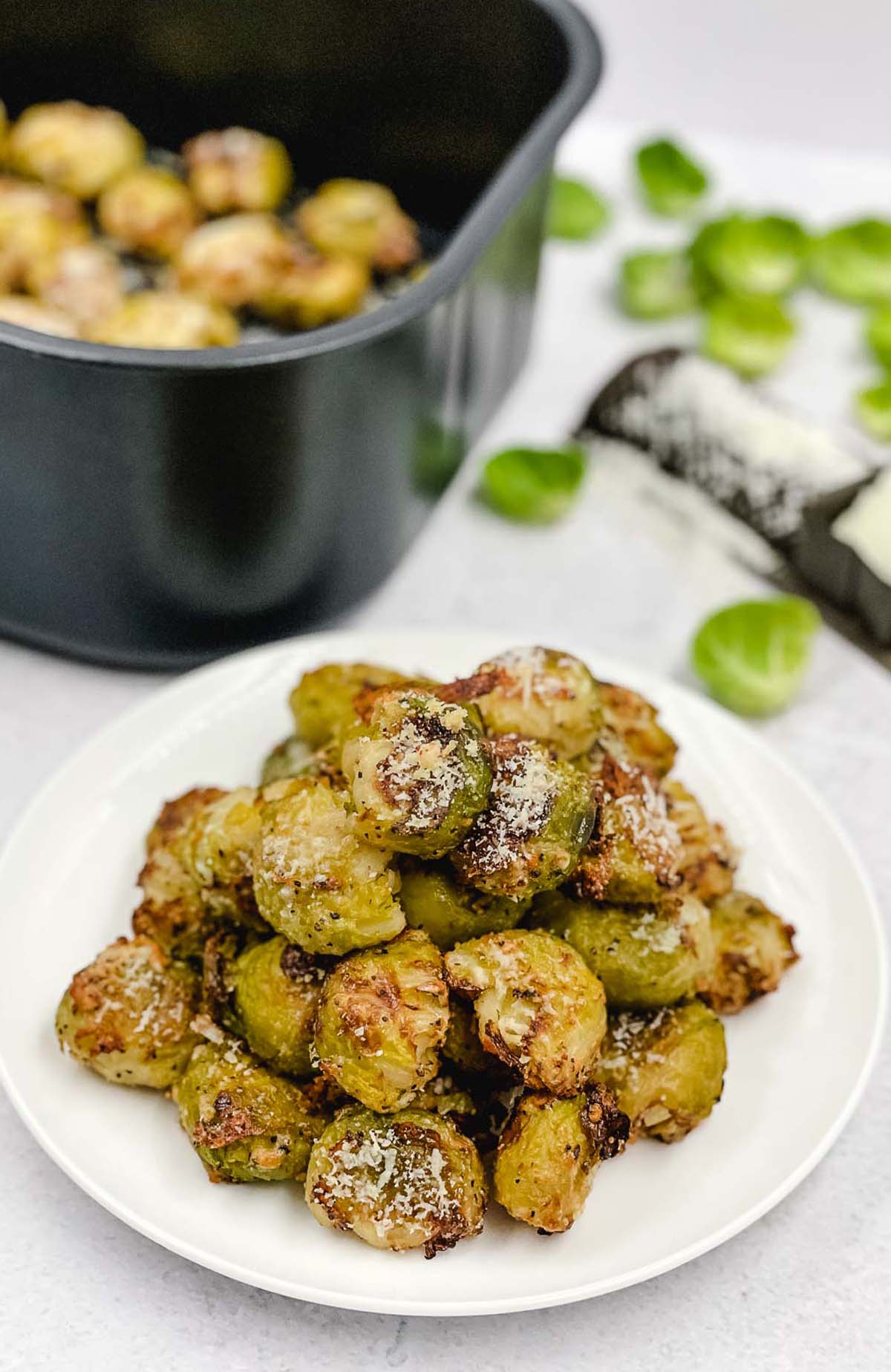 A plate fo freshly air fried smashed Brussels sprouts.