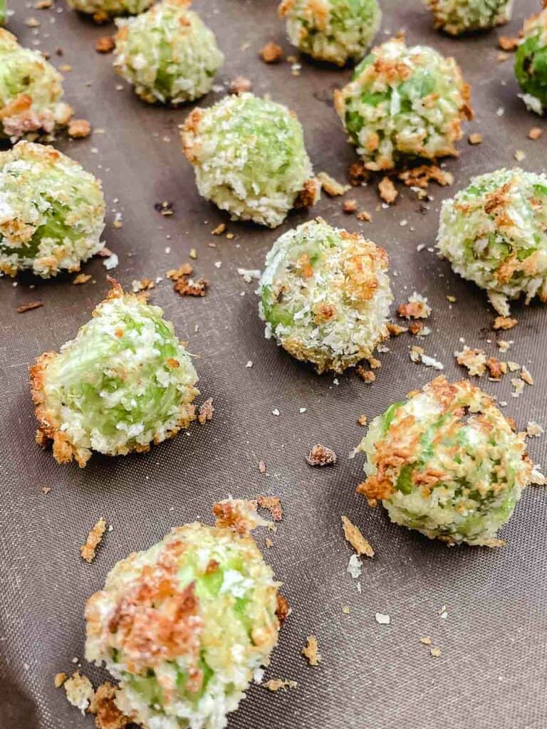 Cooked Brussels sprouts bites on a baking sheet.