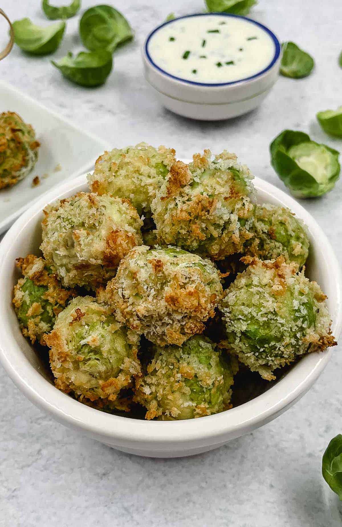 Cheesy Brussels sprouts bites appetizer in a serving bowl.