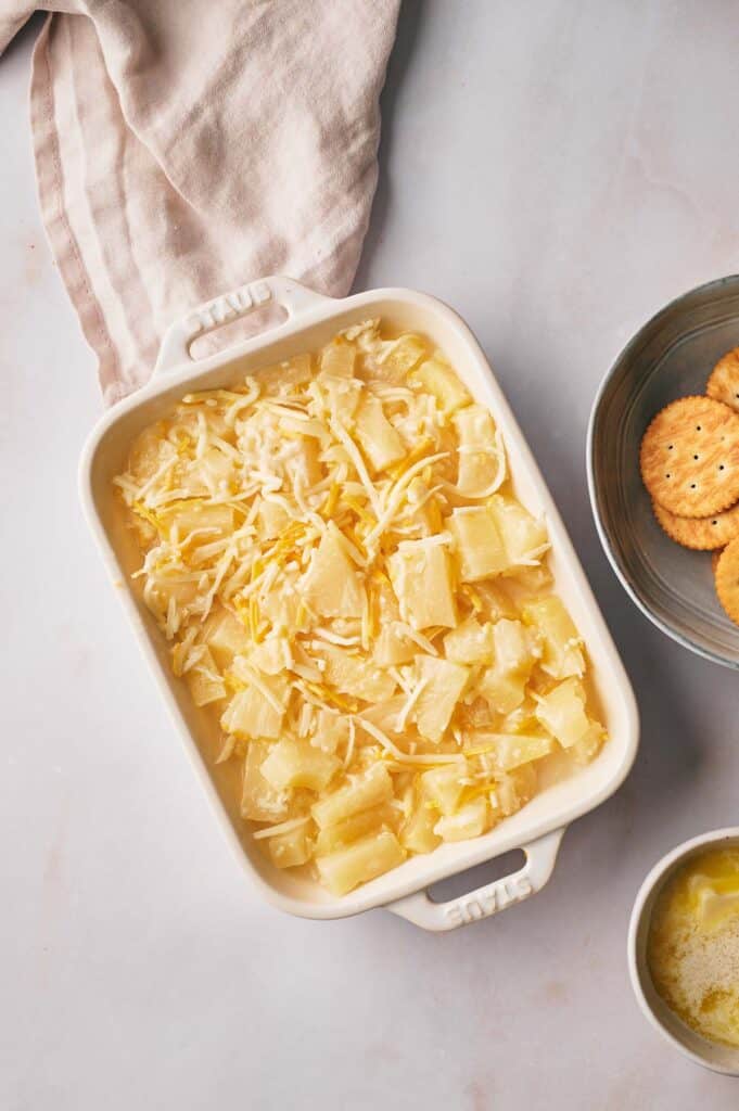Pineapple mixture added to a casserole dish.