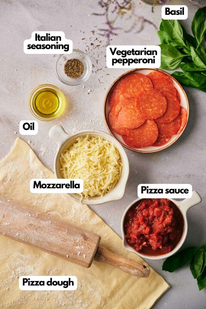 Ingredients needed, Italian seasoning, vegetarian pepperoni, fresh basil, pizza sauce, pizza dough, shredded mozzarella cheese, and olive oil.