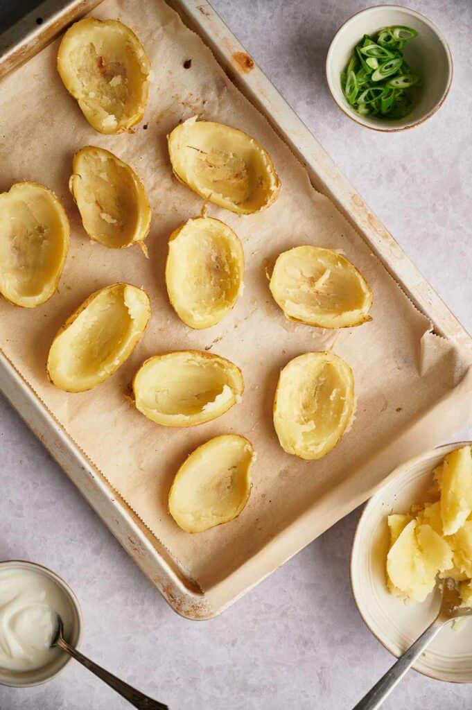 Potato halves with most of the potato flesh scooped out.