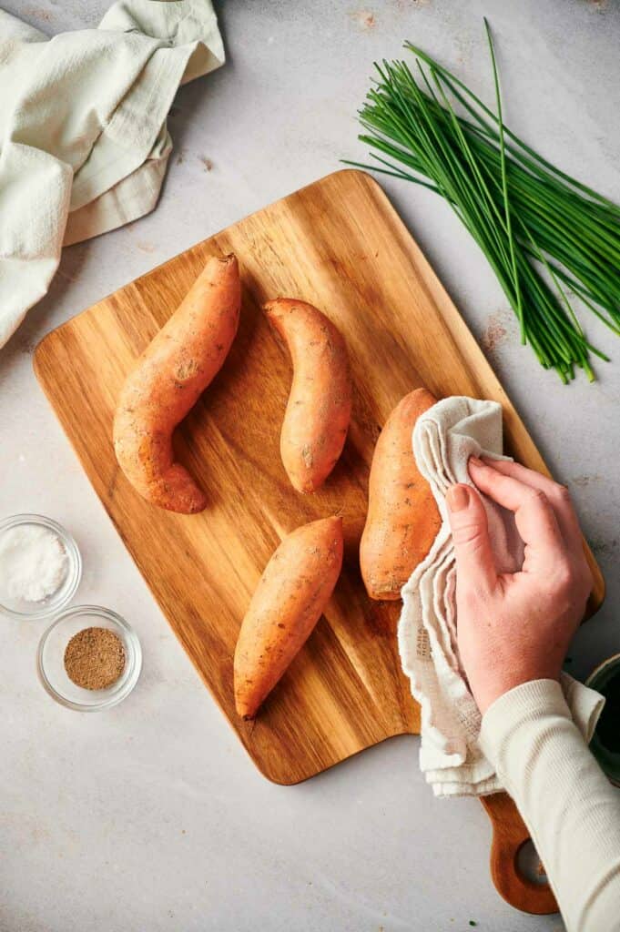 Someone pat drying sweet potatoes.
