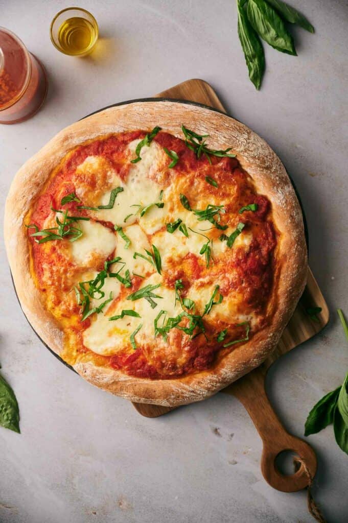 Cooked Neapolitan pizza with fresh basil.
