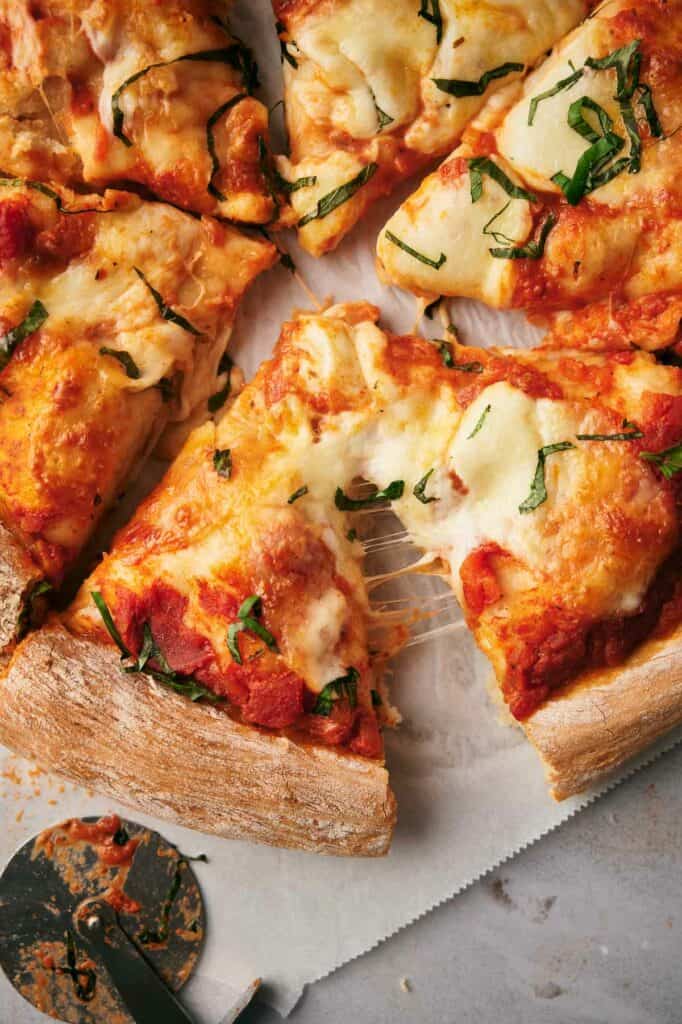 Sliced Neapolitan pizza with pieces pulled apart.