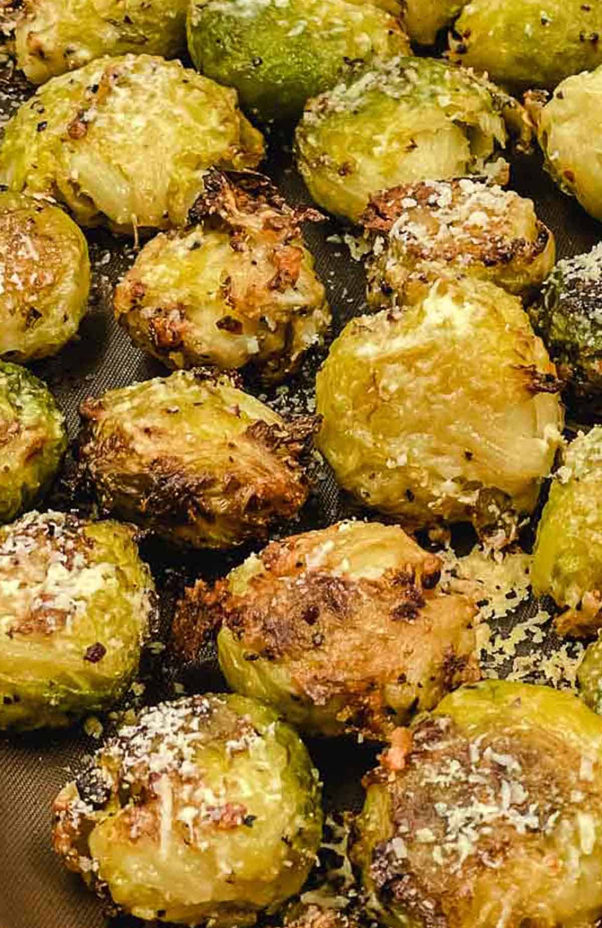 Smashed Brussel sprouts on a baking sheet ready to eat.