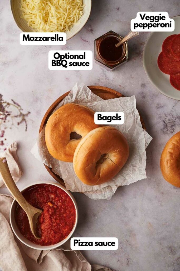 Ingredients needed, mozzarella cheese, veggie pepperoni slices, mini bagels, and pizza sauce.