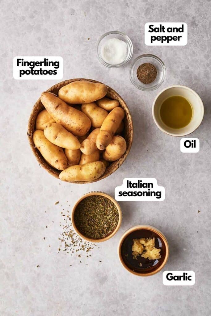 Ingredients needed, fingerling potatoes, salt, pepper, olive oil, Italian seasoning, and fresh minced garlic.
