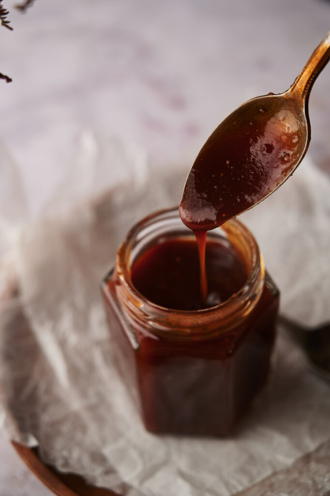 A spoon dripping with the best BBQ sauce.