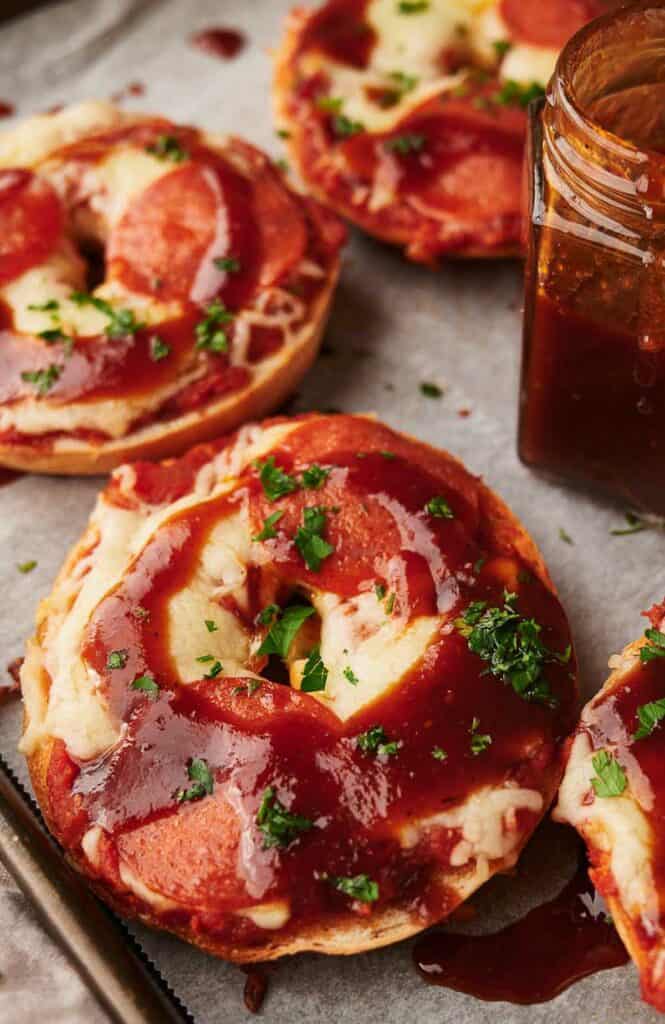 Homemade pizza bagels with BBQ slathered over them.