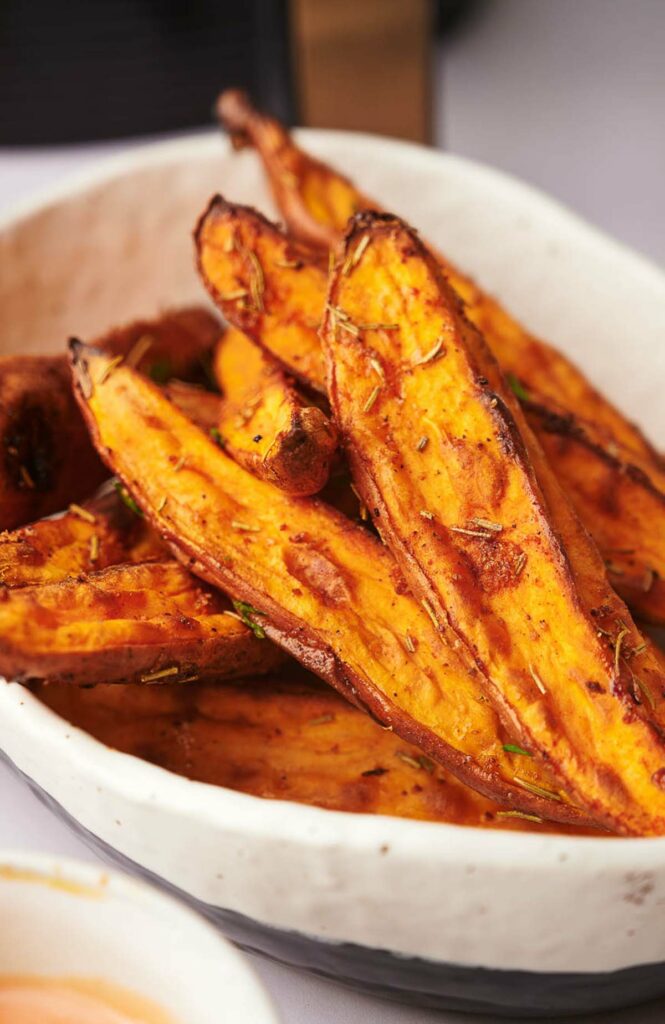 A bowl of freshly made air fryer sweet potato wedges.