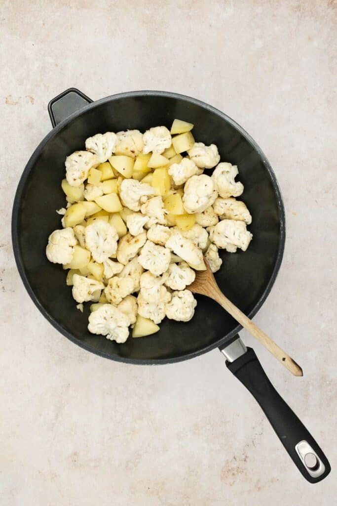 Potatoes and cauliflower in a pan.