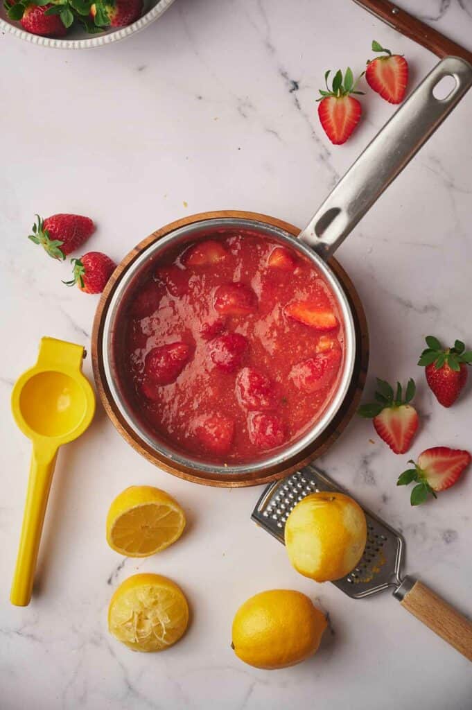 Cooked strawberry topping in a pan.