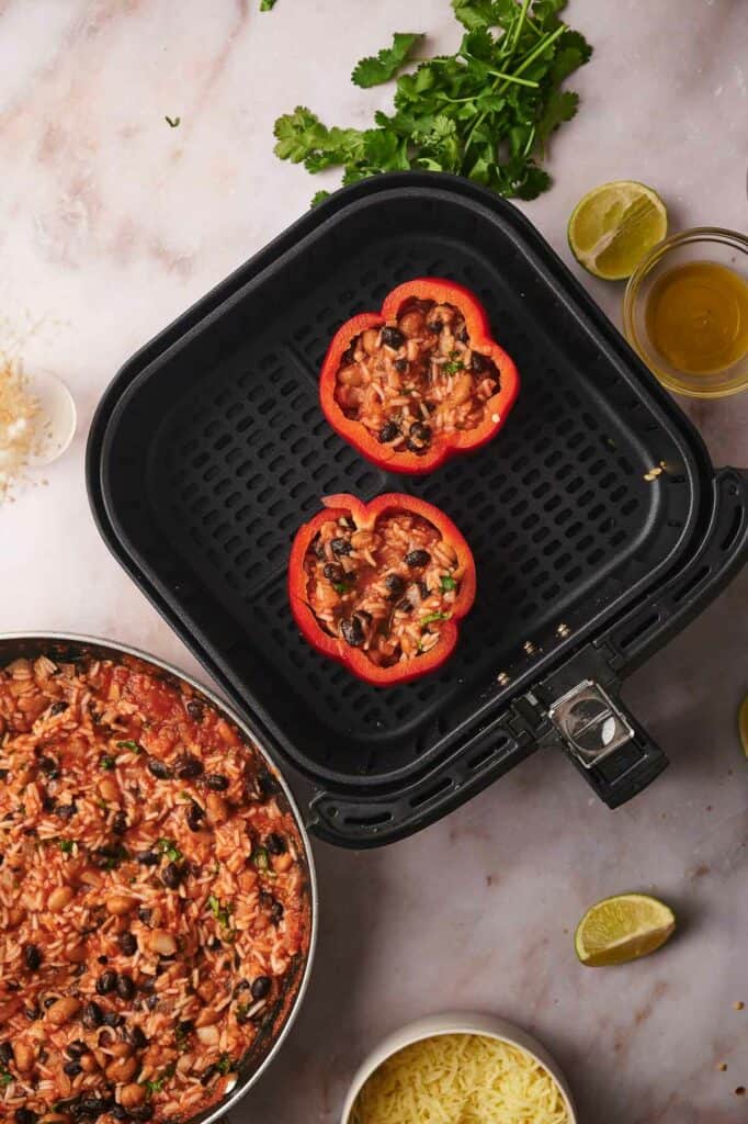 Rice mixture in uncooked bell peppers.