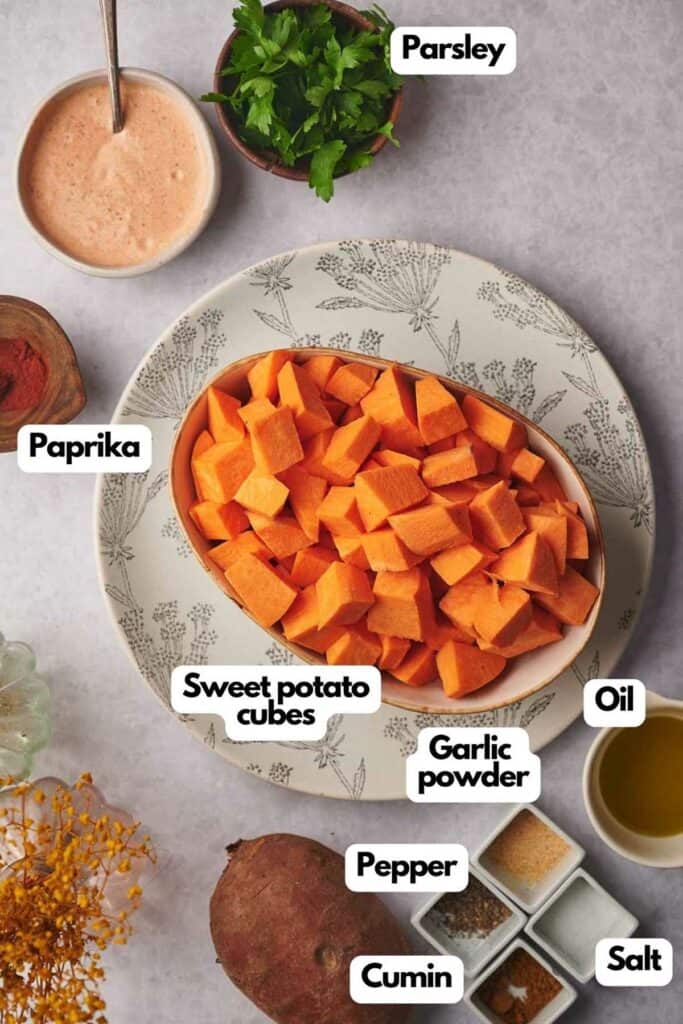 Ingredients needed; fresh parsley, sweet potato, olive oil, garlic powder, black pepper, salt, cumin, and smoked paprika.