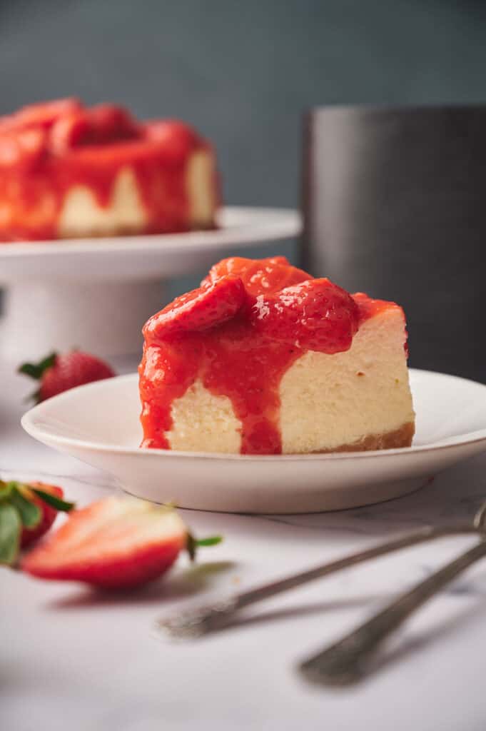 A slice of air fryer strawberry cheesecake on a plate.