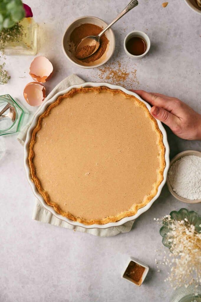 The cinnamon pie filling is placed into a prepared pie shell.