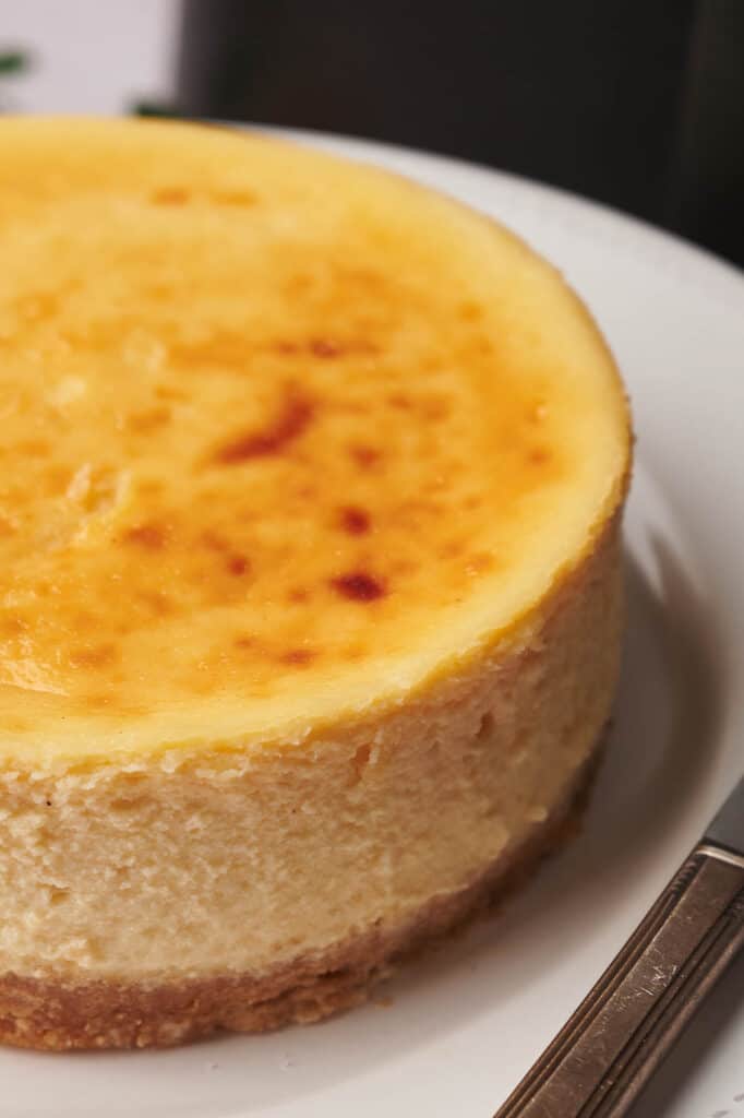 A close up of a cheesecake made in an air fryer on a plate.