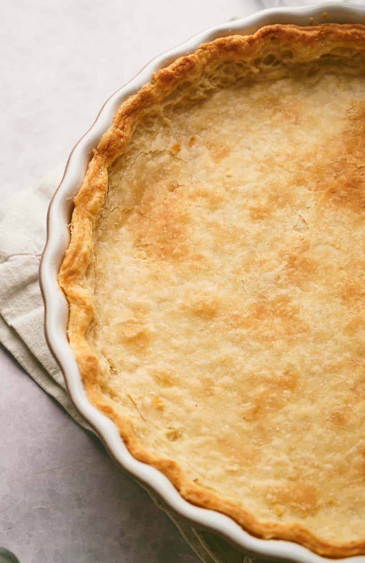 Homemade pie crust in a pie dish.