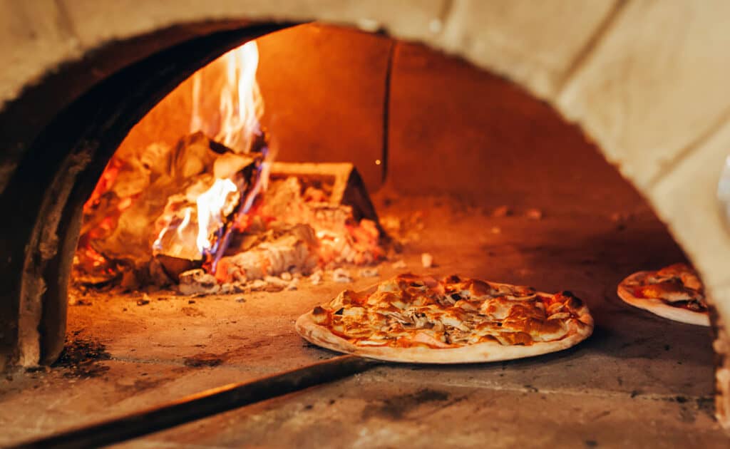 Pizzas cooking in a pizza oven