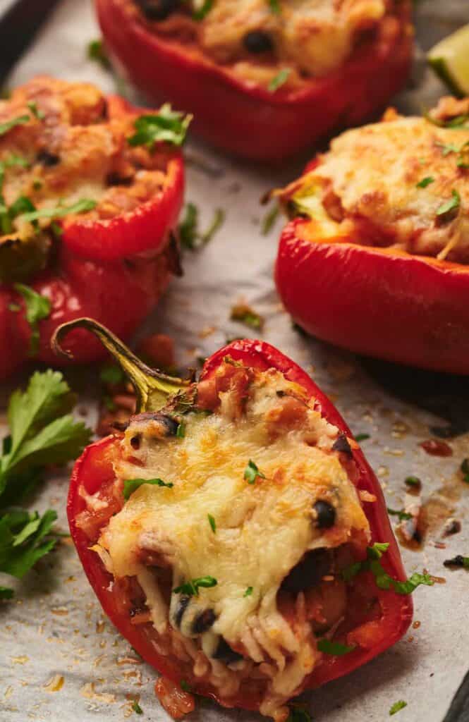 Delicious vegetarian stuffed peppers on a baking sheet.