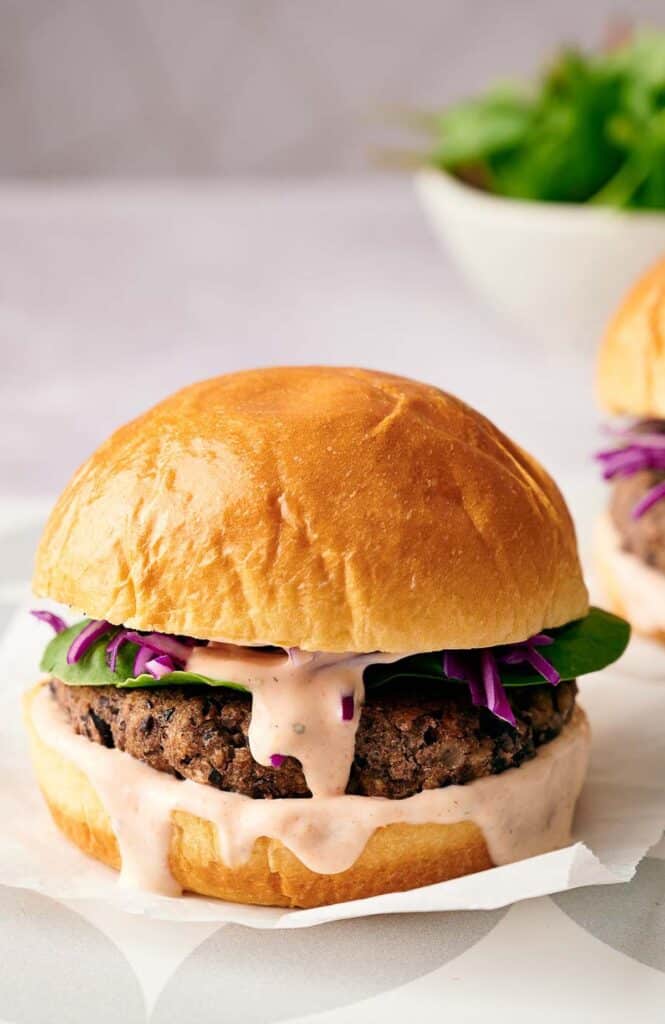 A delicious homemade black bean burger in a burger bun, ready to eat.