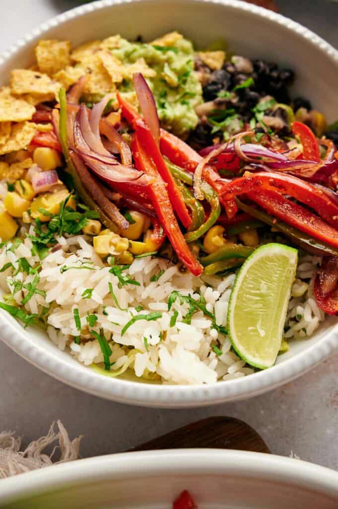 A delicious Copycat Chipotle burrito bowl with a lemon wedge on top.