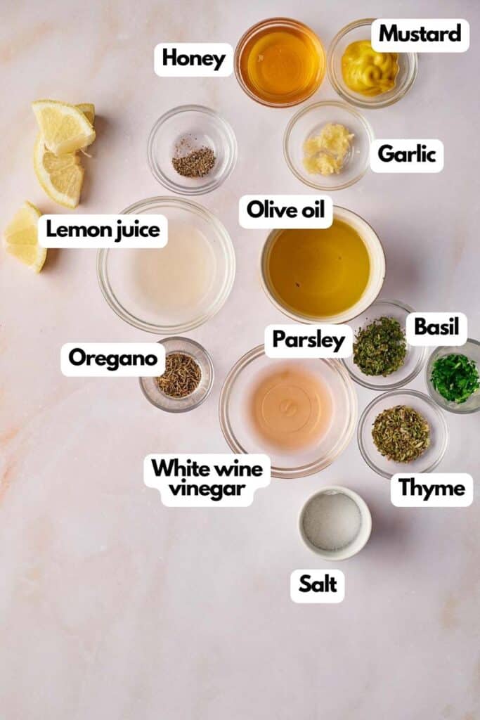 Ingredients needed; lemon juice, honey, pepper, mustard, garlic, olive oil, basil, thyme, parsley, salt, white wine vinegar, and oregano.