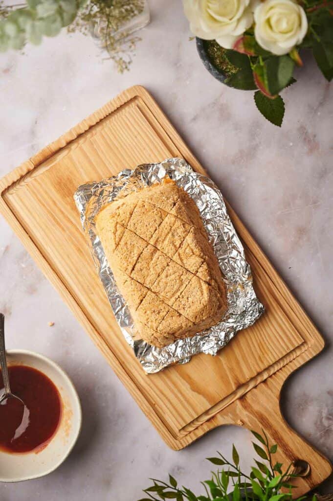 Vegan ham with a criss cross pattern on the top.