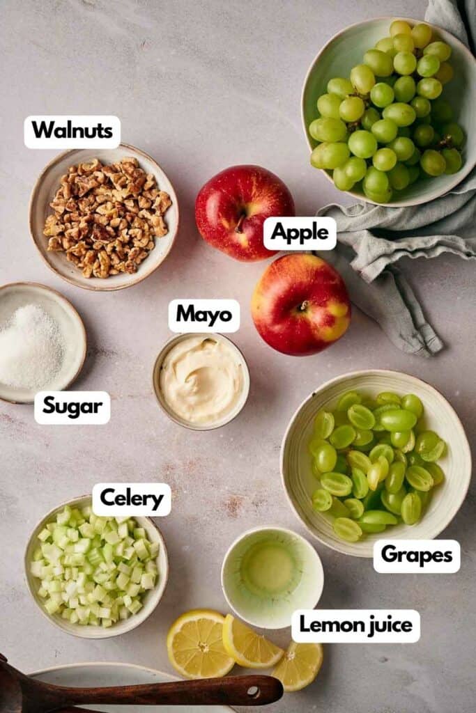 Ingredients needed; walnuts, red apples, grapes, mayonnaise, lemon juice, celery, and sugar.