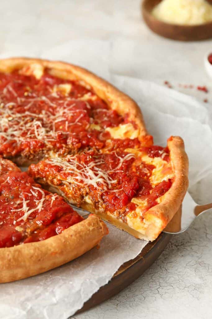 Tasty Chicago-style pizza on light background.