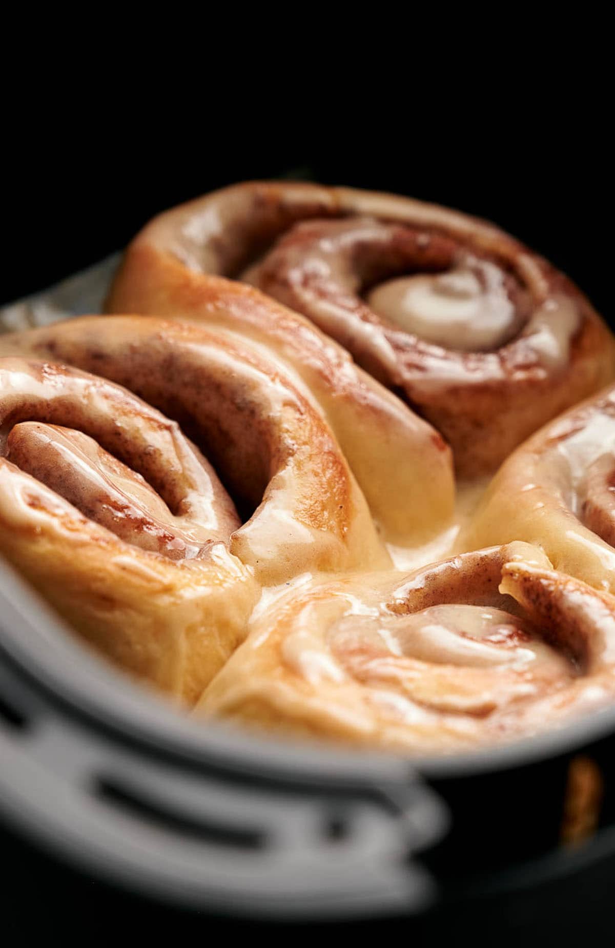 Homemade cinnamon rolls in the air fryer basket.