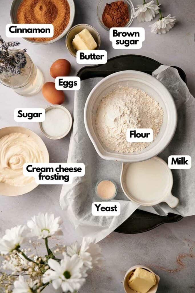 Ingredients needed; cinnamon, unsalted butter, brown sugar, eggs, flour, milk, yeast, cream cheese frosting, and sugar.