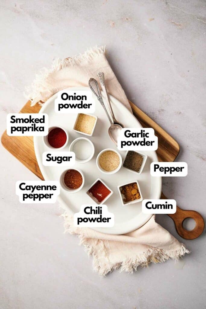 Ingredients needed; smoked paprika, onion powder, garlic powder, pepper, ground cumin, chili powder, Cayenne pepper, and sugar.