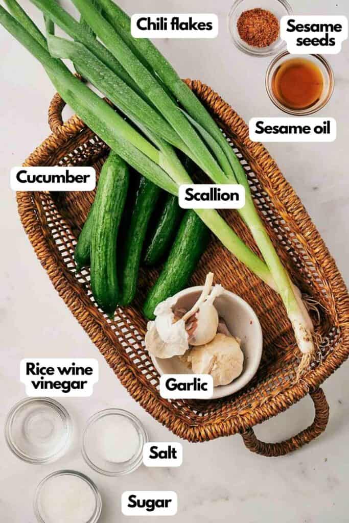 Ingredients needed; cucumber, scallion, chili flakes, sesame oil, sesame seeds, garlic, sugar, salt, and rice wine vinegar.