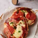 Air fryer pizza bagels with veggie pepperoni on a plate.