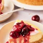A slice of cherry cheesecake on a plate.