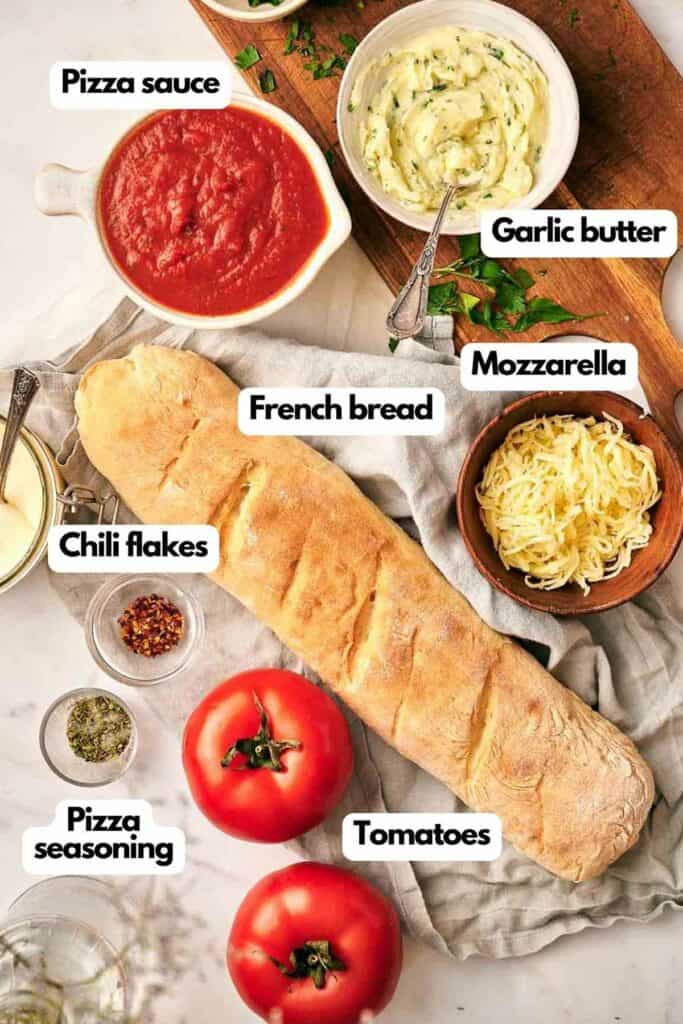 The ingredients for a French bread pizza are laid out on a table.