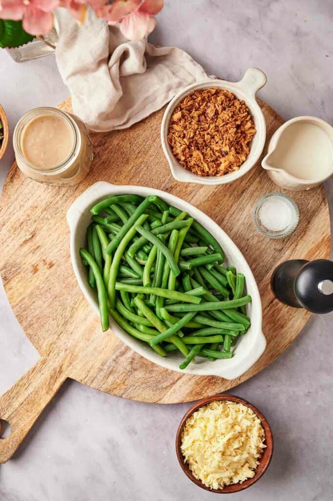 Green beans and other ingredients on a cutting board.