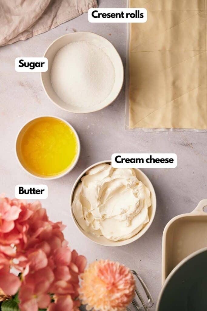The ingredients for a cheesecake are shown on a table.