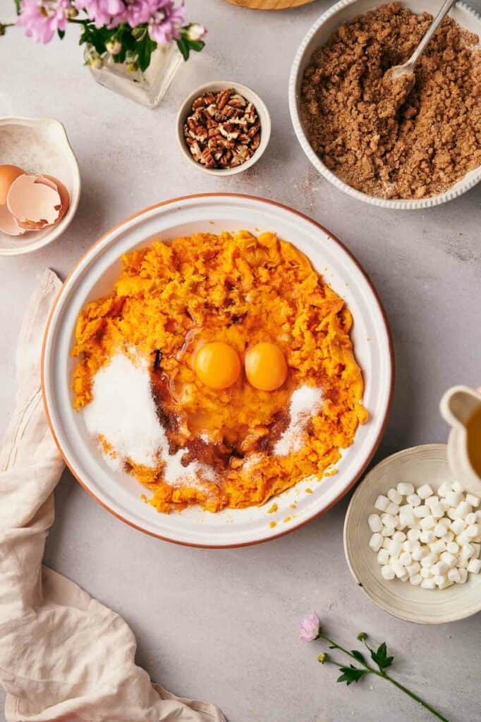 A bowl of sweet potato mash with eggs and other ingredients.