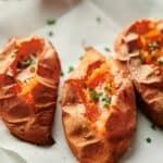 Baked sweet potatoes on a white plate.
