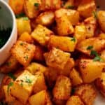 Breakfast potatoes on a white plate.