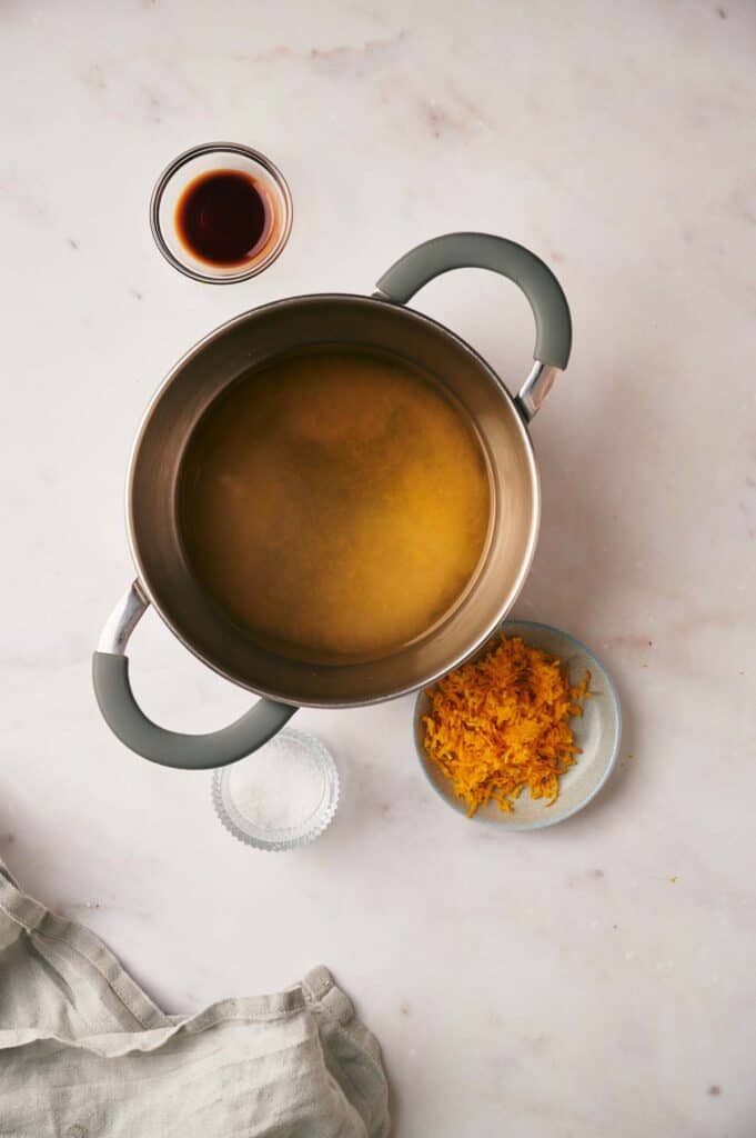 A pot with ingredients on a marble countertop.