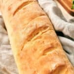 A loaf of french bread on a cutting board.